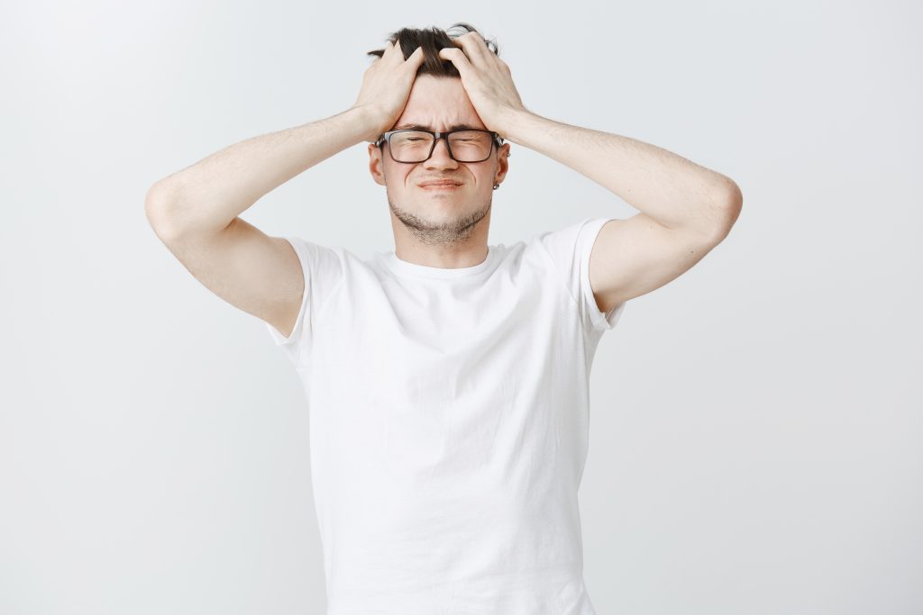 troubled exhausted young man grab head close eyes from overthinking 1