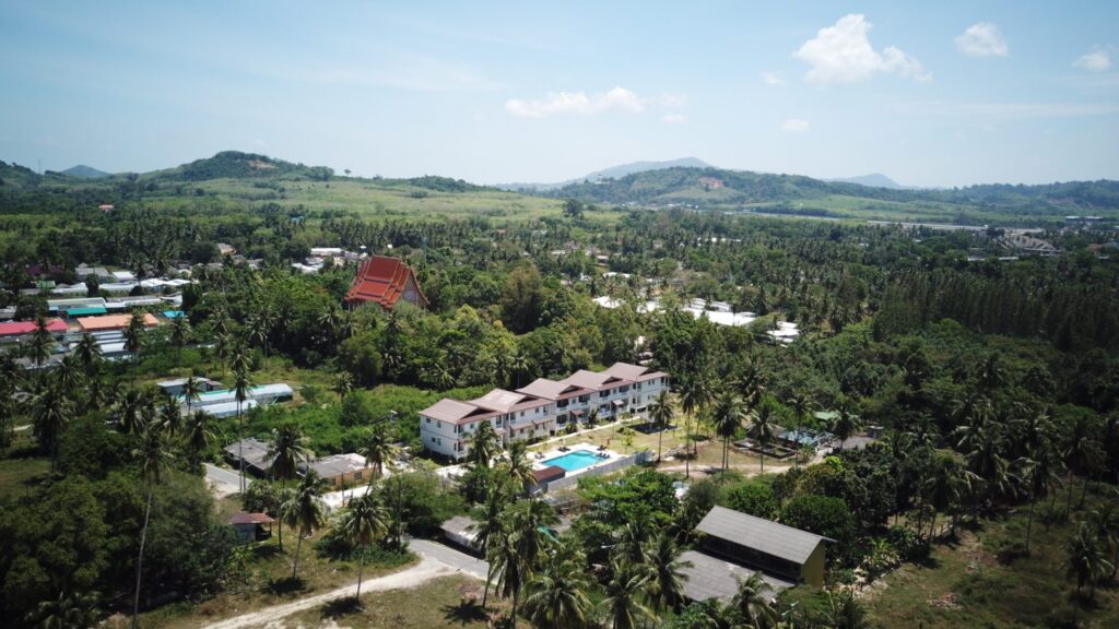 Motorbike Rental at Mai Khao 4 Aerial view of resorts among coconut palms and green hills in Mai Khao