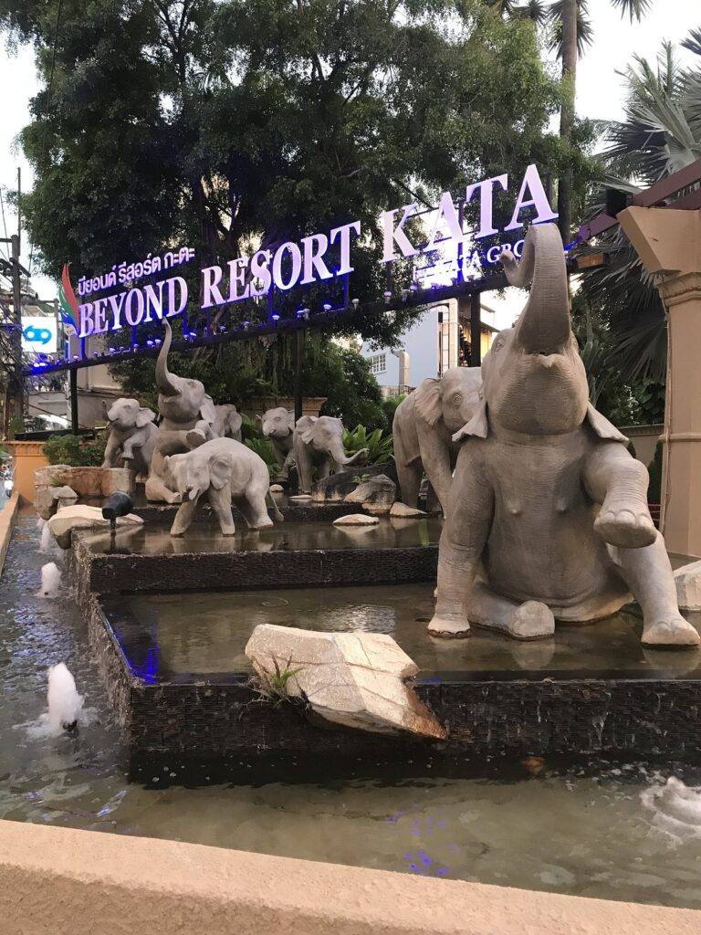 Hotel Doorstep Bike Delivery Phuket: Your Complete Guide to Hassle-Free Scooter Rentals 28 Entrance sign of Beyond Resort Kata with elephant statues and a fountain in Phuket