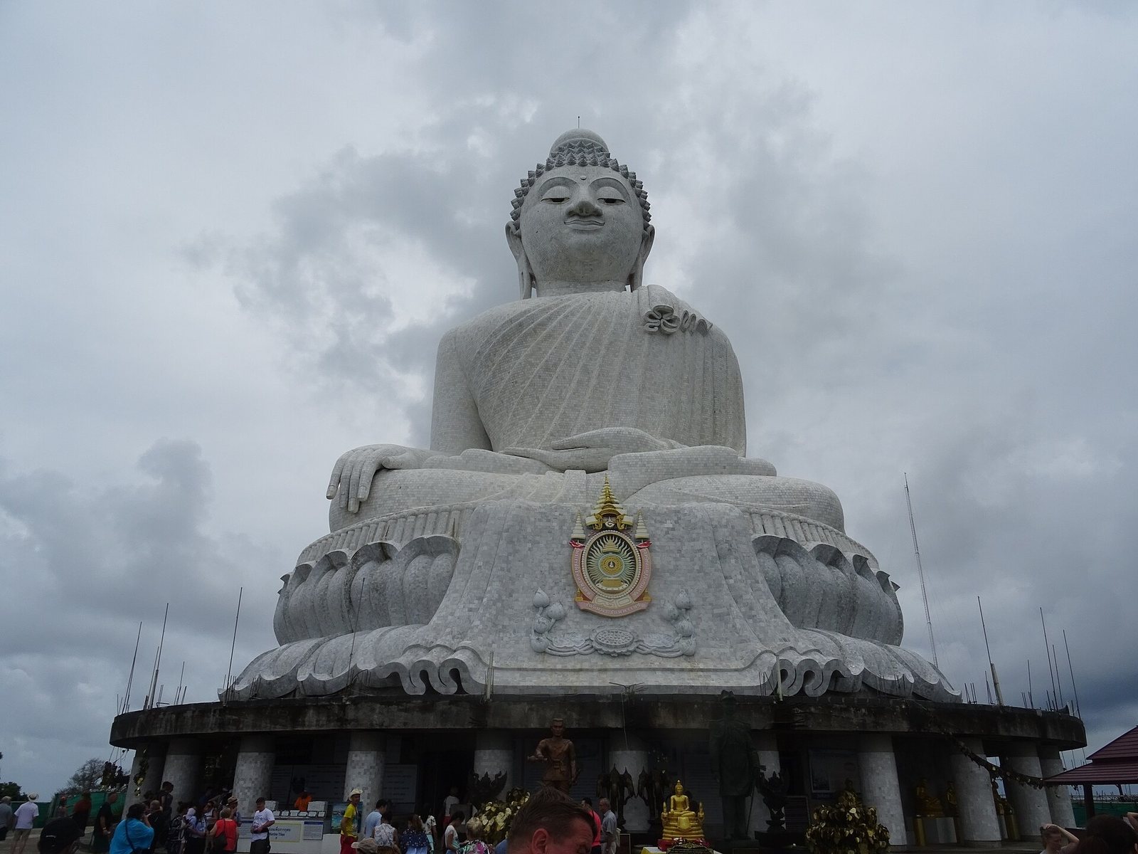 Big Buddha white marble statue on Nakkerd Hill under grey clouds in Phuket