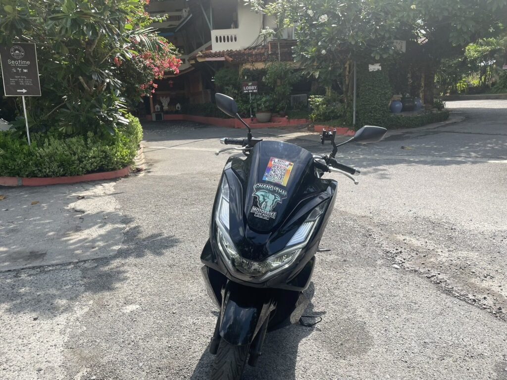 Motorbike Rental at Kalim Beach 3 Black Honda PCX scooter parked at a hotel entrance driveway in Kalim