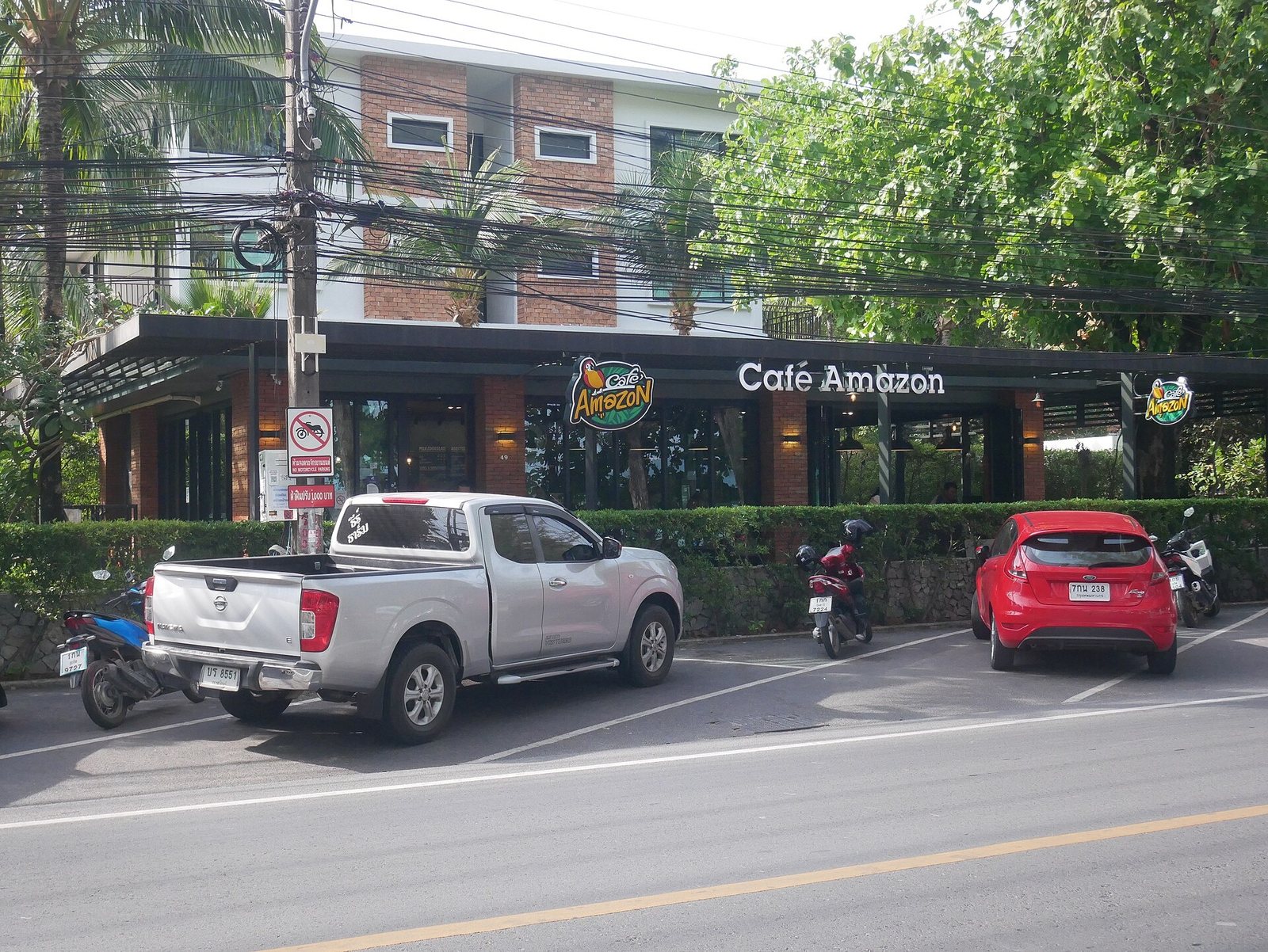 Cafe Amazon on the main road in Rawai, Phuket, with a pickup truck and cars parked outside