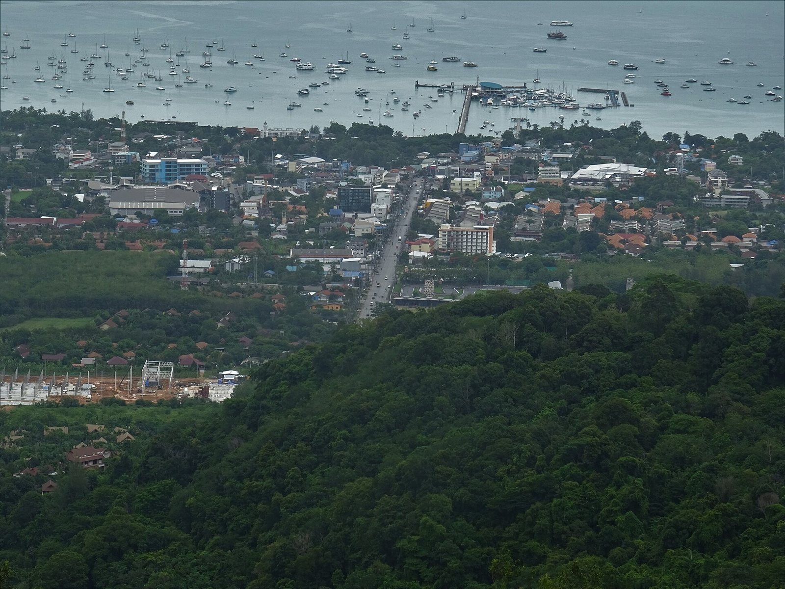 Chalong Pier and bay in Phuket with many boats seen from the hills above