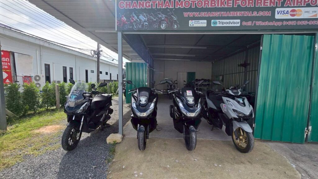 Motorbike Rental at Phuket International Airport 4 Honda and Yamaha rental scooters lined up under the green roof of the Chang Thai airport branch