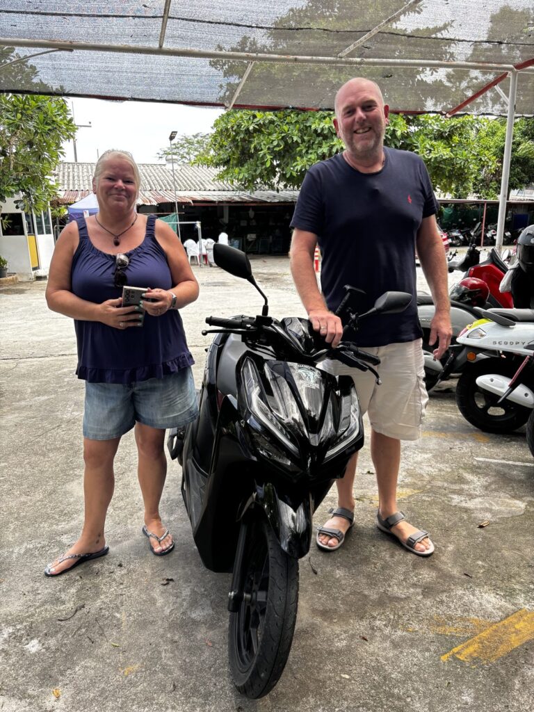 Motorbike Rental in Chalong 3 Couple collecting a black Honda scooter at the Chang Thai Chalong branch