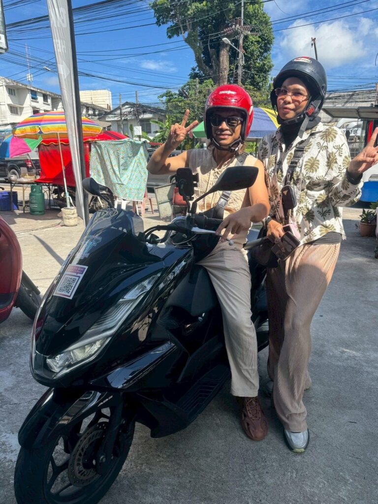 Motorbike Rental at Karon Beach 4 Couple in helmets on a black Honda PCX at Karon Beach