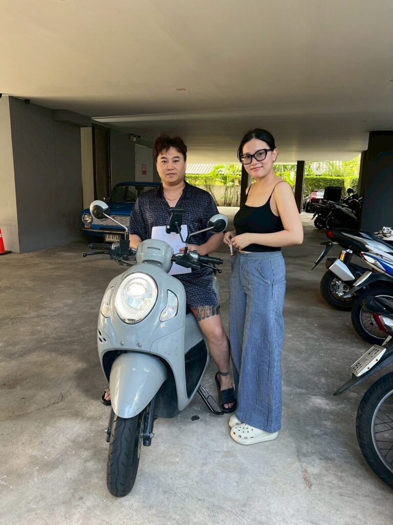 Motorbike Rental at Kamala Beach 4 Couple receiving a grey Honda Scoopy at a Kamala villa car park
