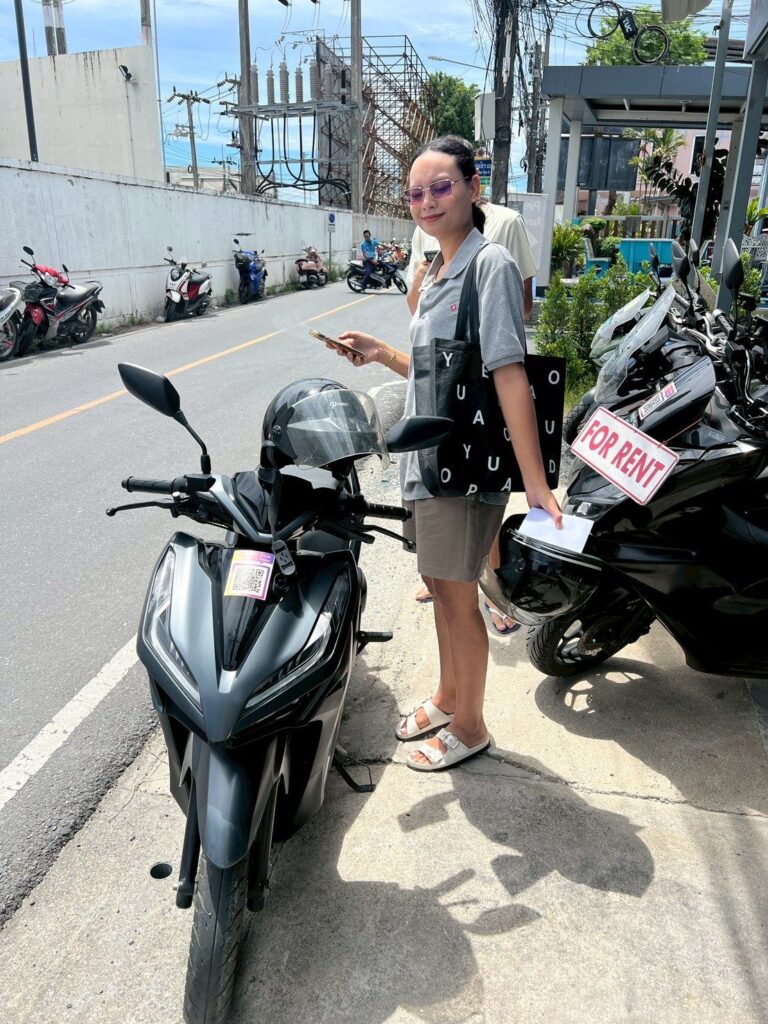 Motorbike Rental at Phuket International Airport 8 Customer with a black Honda scooter marked for rent near Phuket Airport