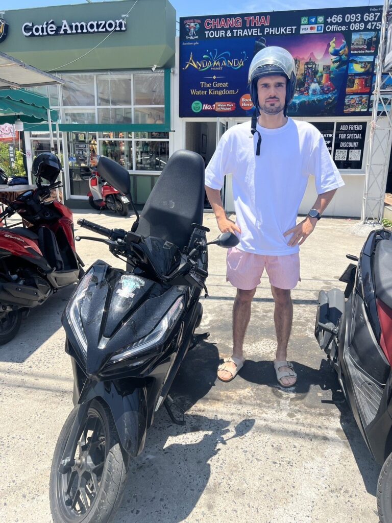 Motorbike Rental in Chalong 5 Customer with a black Honda scooter in front of Cafe Amazon next to the Chalong branch