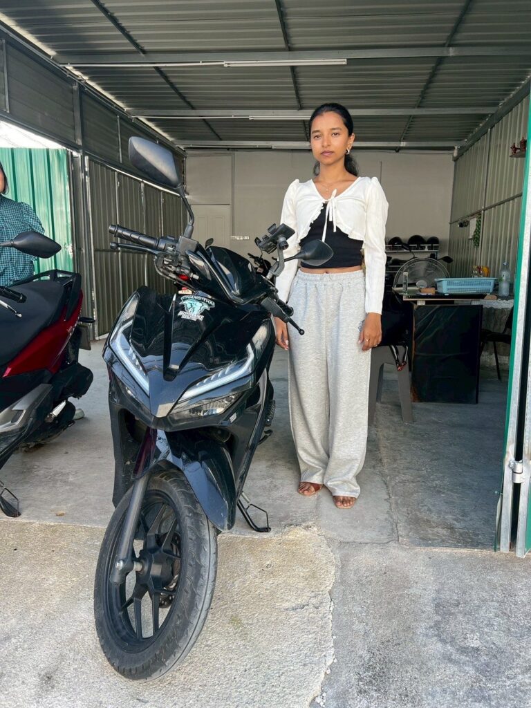 Motorbike Rental at Phuket International Airport 10 Customer beside a black Honda scooter inside the Chang Thai airport branch