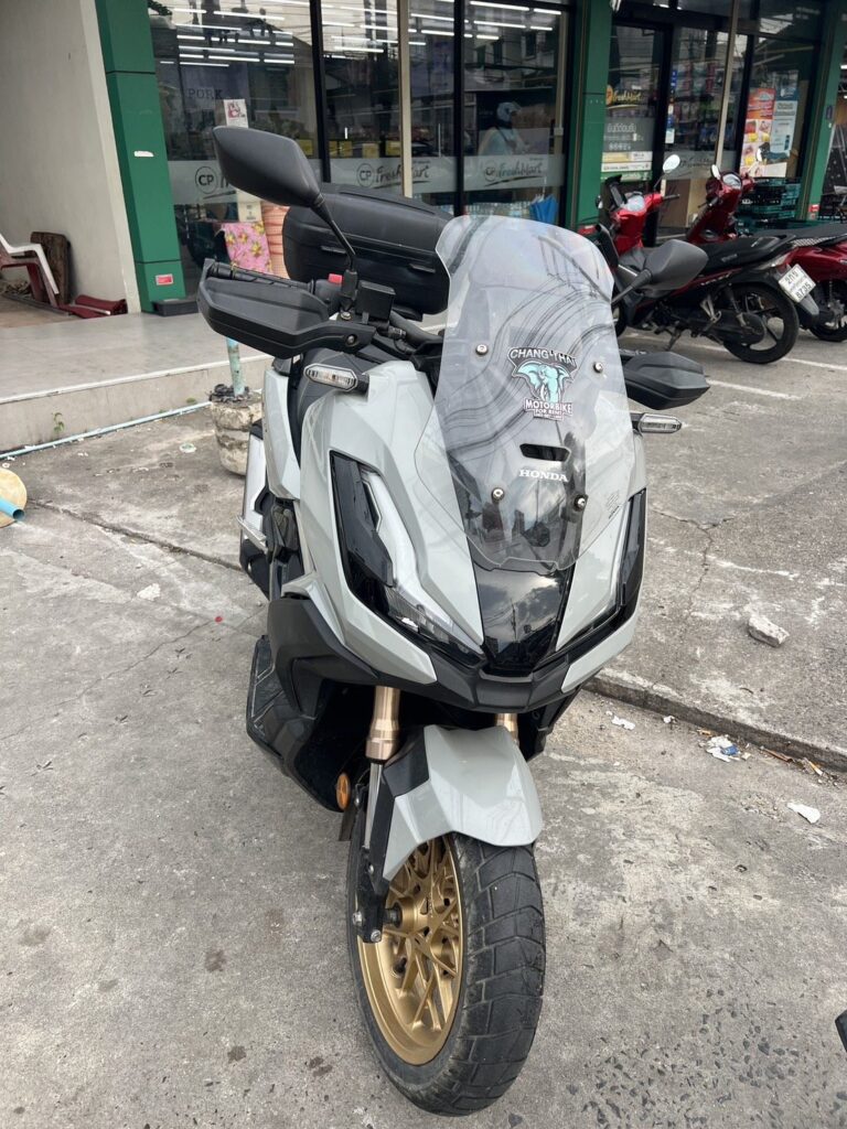 Motorbike Rental at Kalim Beach 2 Grey Honda ADV scooter with gold wheels parked outside a shop near Kalim Beach
