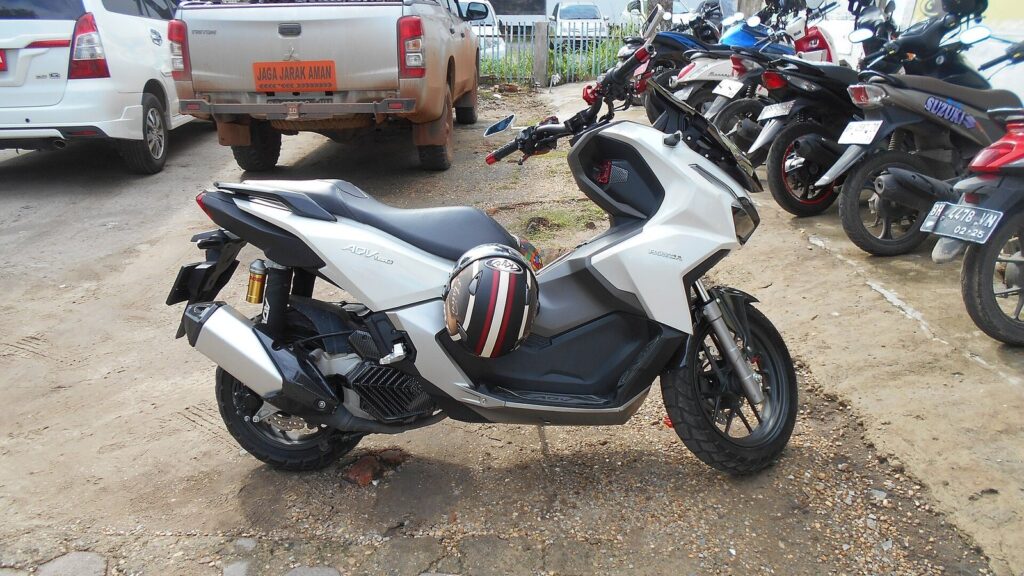Honda PCX 160 vs Yamaha NMAX 155 vs Honda ADV 160 — Which Scooter Should You Rent in Phuket? (2026 Guide) 3 Honda ADV160 adventure scooter in white parked beside other motorbikes