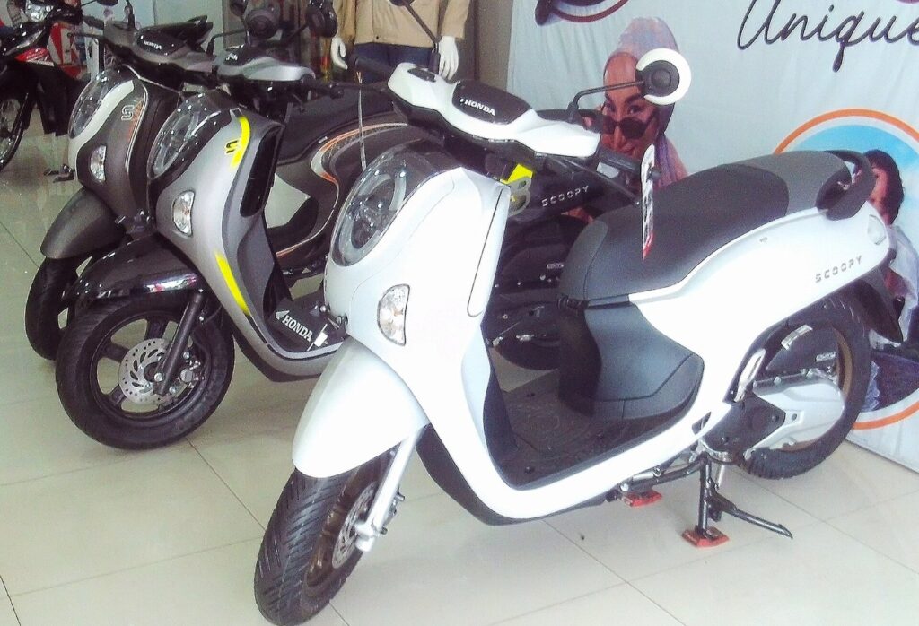 Full Fleet Spec Sheet: Every Scooter Chang Thai Rents in Phuket (2026) 2 Honda Scoopy scooters lined up in a showroom, white in front