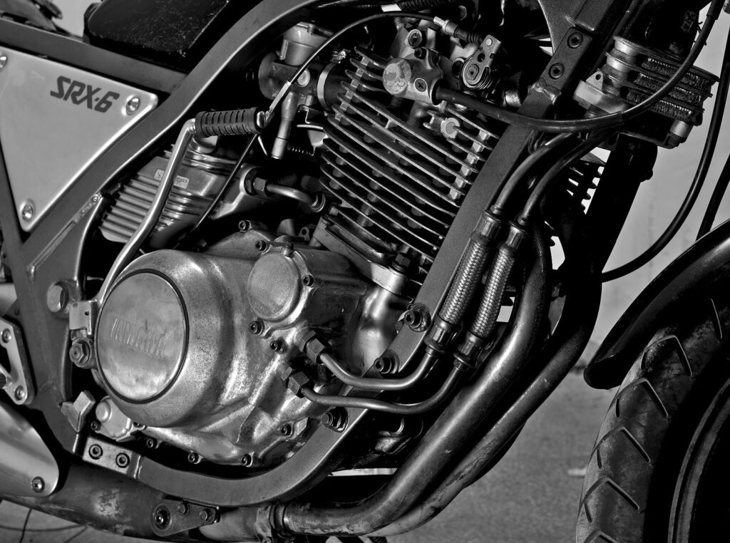 Long-Term Scooter Rental Phuket — Monthly & Expat Guide 2026 5 Black and white detail of a large single cylinder motorcycle engine
