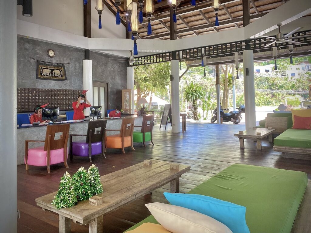 Long-Term Scooter Rental Phuket — Monthly & Expat Guide 2026 4 Open air lobby of a resort in Phuket with wooden pillars and bright cushions