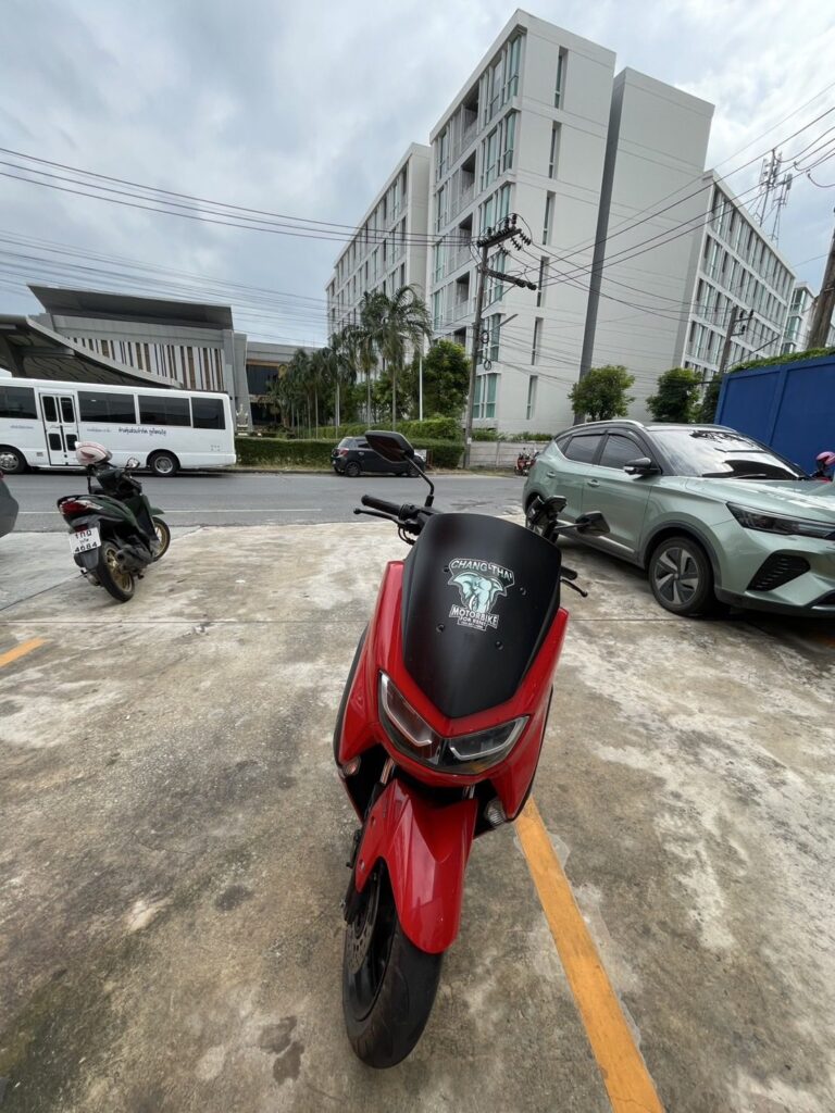 Motorbike Rental at Surin Beach 2 Red Yamaha NMAX 155 scooter parked in a car park beside a residential building
