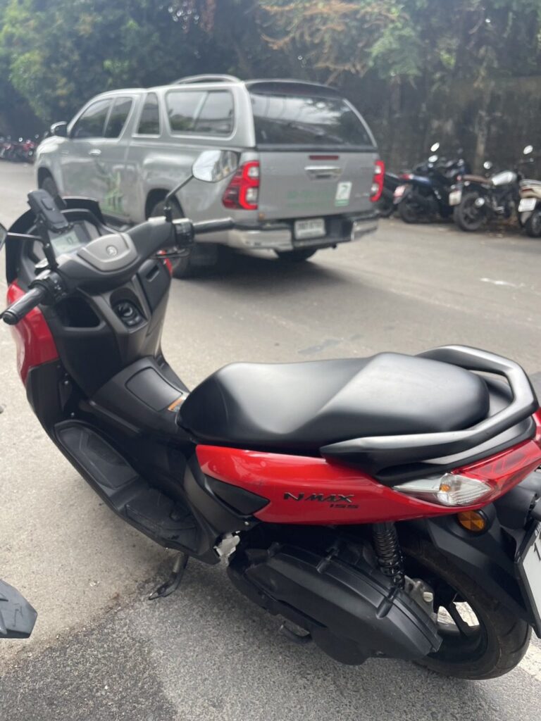 Motorbike Rental at Cape Panwa 3 Rear view of a red and black Yamaha NMAX scooter parked at the roadside in Cape Panwa
