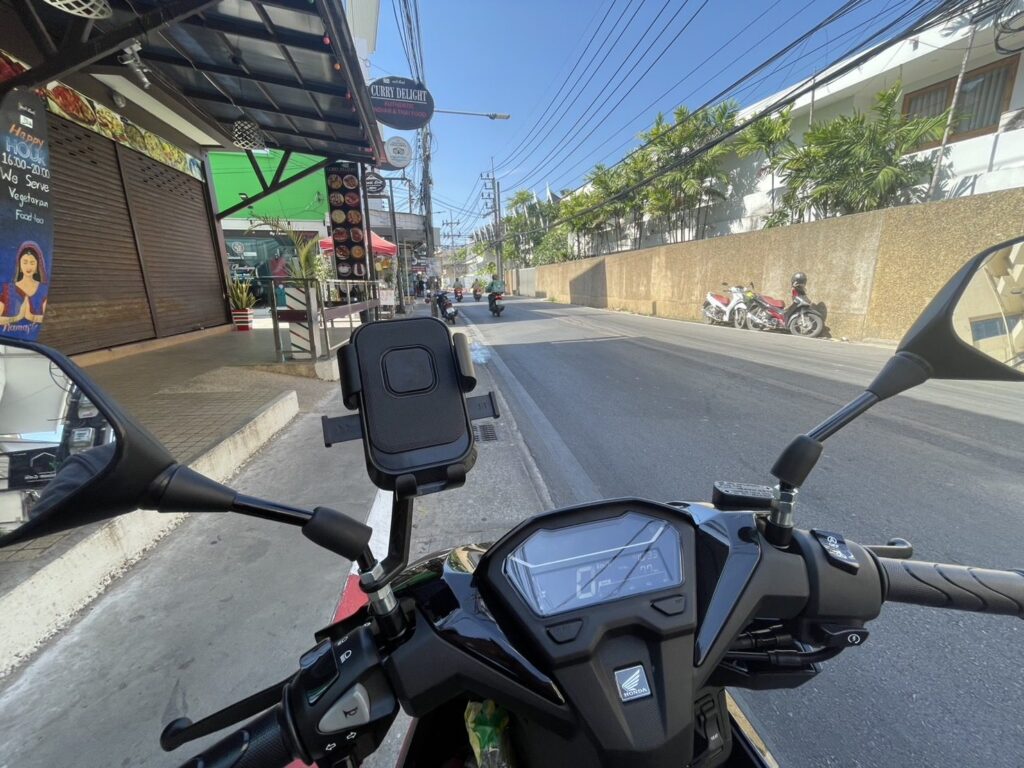 Motorbike Rental at Kata Noi 2 Rider's view over the handlebars and phone holder along a road in Kata