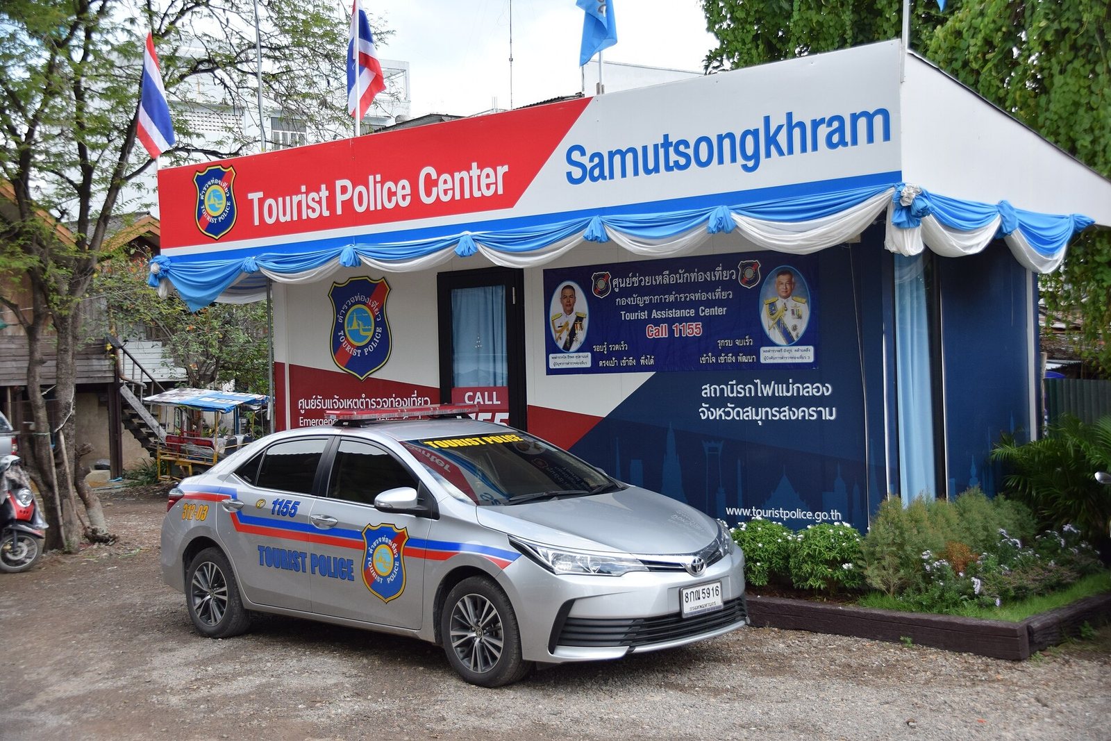 Thai Tourist Police patrol car parked in front of a Tourist Police Center