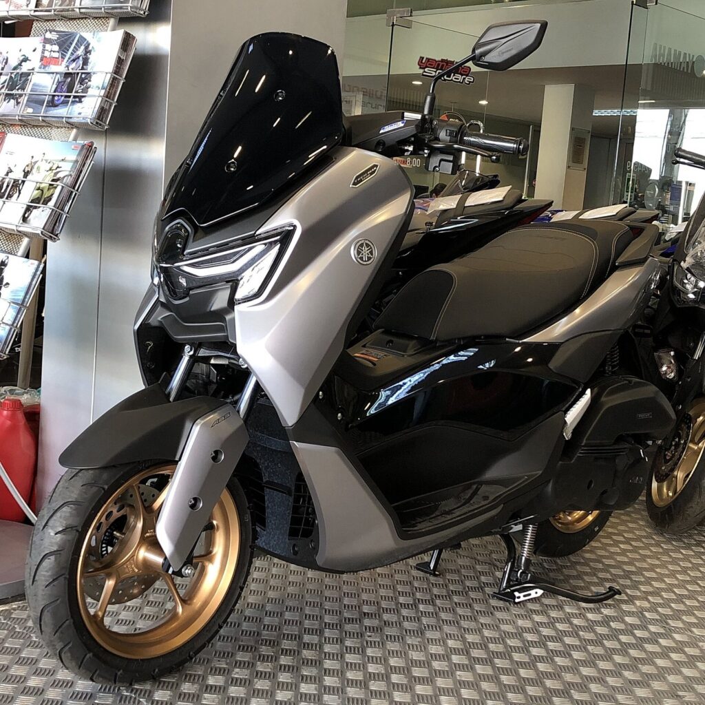 Yamaha NMAX 155 Phuket Rental: Full Review and Price 2026 3 Black and grey Yamaha NMAX 155 Tech MAX scooter in a showroom