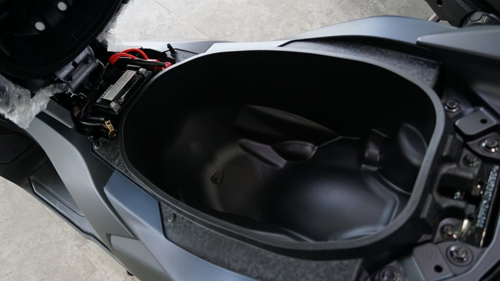 Premium Scooter Rental Phuket: Is It Worth the Extra Baht? (2026) 3 Open under seat storage compartment of a Yamaha NMAX scooter